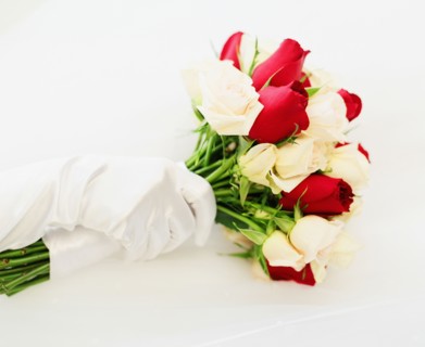 Gloved hand with wedding bouquet