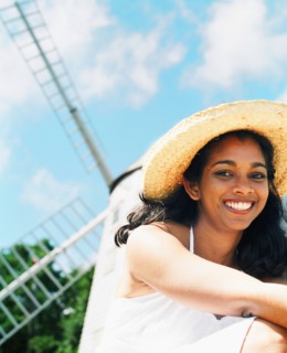 Young woman smiling with sun hat