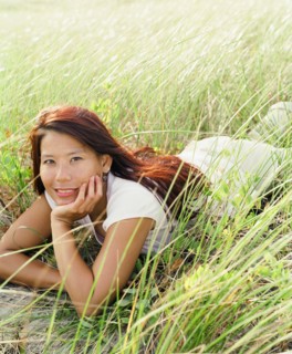 Young woman laying in sea grass