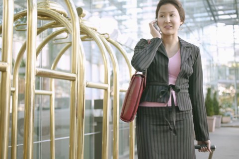 Businesswoman on mobile phone in hotel lobby
