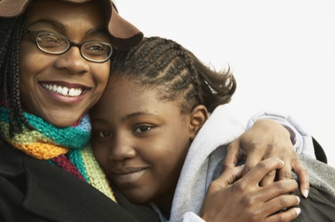 Mother hugging daughter