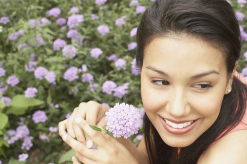 Close up of young woman holding flower