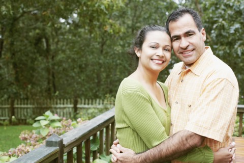 Couple hugging in their backyard