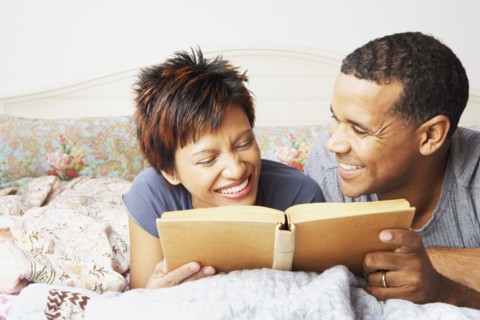 Young couple reading in bed