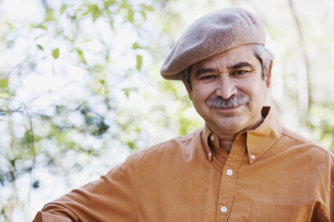Middle-aged man wearing cap outdoors