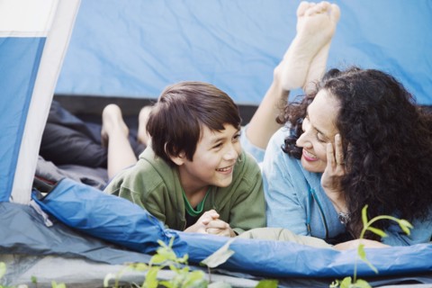 Mother and son laying in tent talking