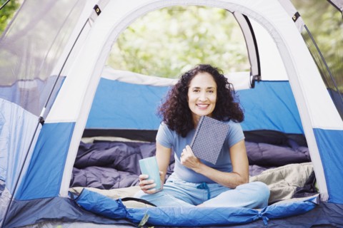 Woman with coffee in tent