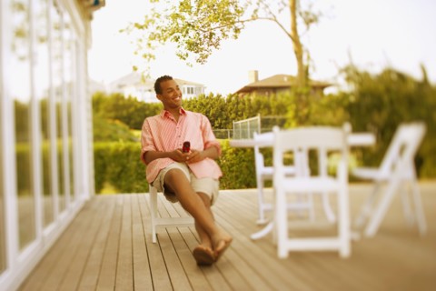 Hispanic man sitting on patio