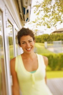 Young woman leaning against glass door