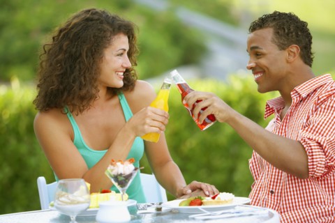 Couple toasting at outdoor restaurant