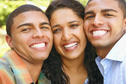 Hispanic siblings hugging
