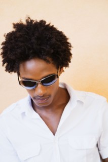 African man wearing sunglasses and looking down