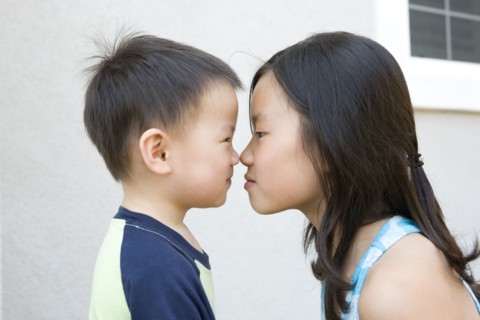 Chinese brother and sister staring at one another