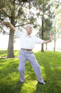 Senior Chinese man doing tai chi outdoors