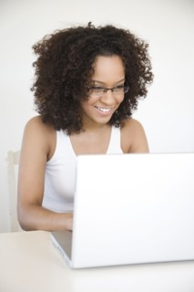 Hispanic woman using laptop