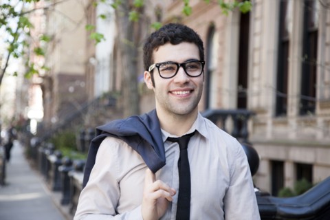 Hispanic businessman walking on city sidewalk