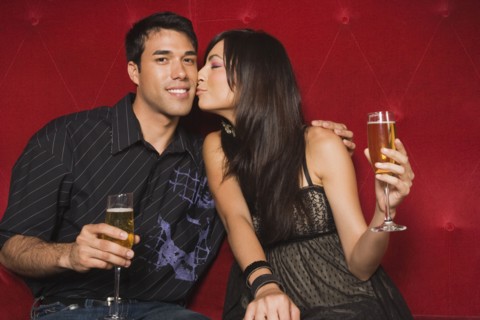 Middle Eastern woman kissing boyfriend's cheek