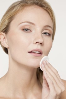 Caucasian woman applying makeup