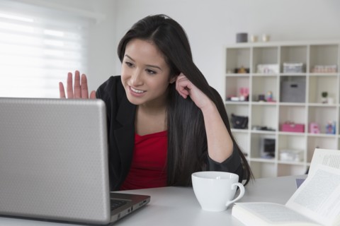 Mixed race businesswoman using laptop