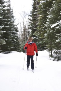 Caucasian man cross country skiing in snowy landscape