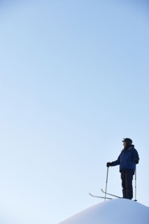 Caucasian skier on hilltop