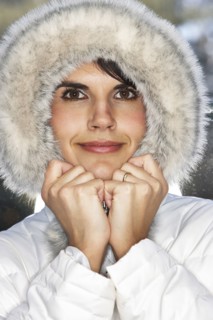 Caucasian woman wearing fur hood