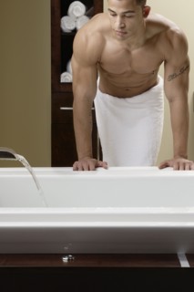 Mixed race man running bath