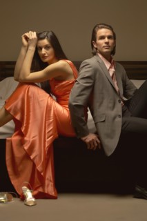 Couple sitting on bed