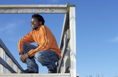 Black man on wooden dock outdoors