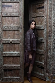 Hispanic woman standing in ornate doorway