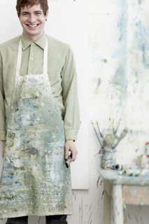 Caucasian artist smiling in studio