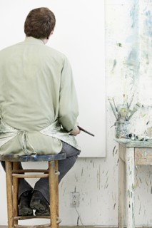 Caucasian painter working in studio