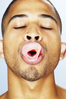 Mixed race man popping bubble gum