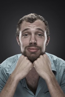 Sad man with hands on chin