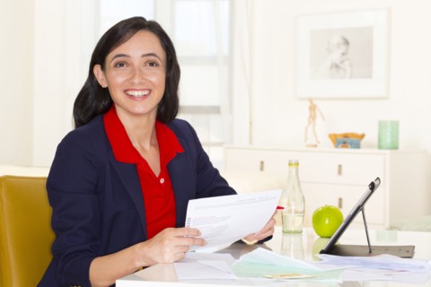 Mixed race businesswoman working at desk