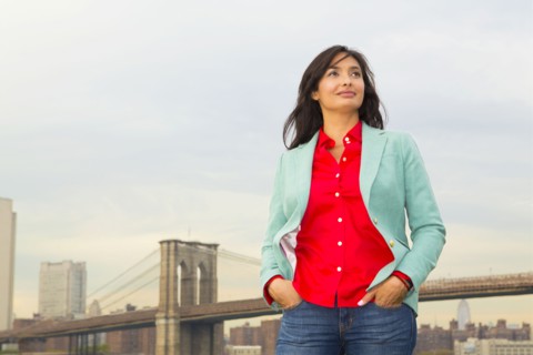 Mixed race woman and city skyline