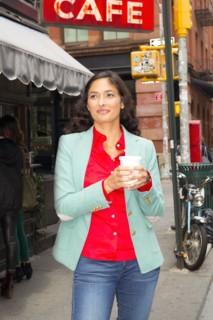 Mixed race woman drinking cup of coffee in city