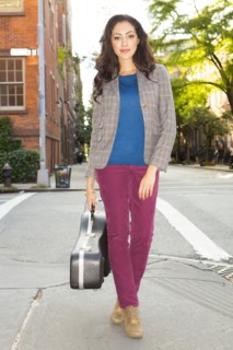 Mixed race woman carrying guitar case