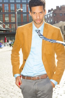 Mixed race businessman walking on city street