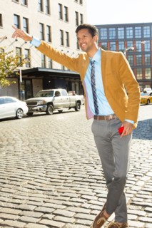 Mixed race businessman hailing taxi on city street