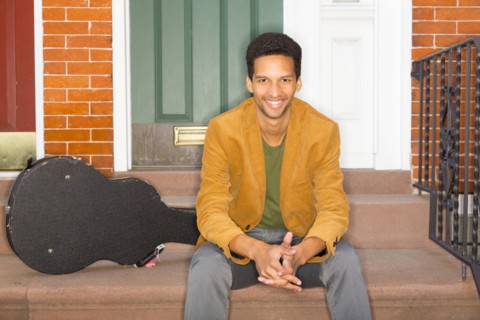 Mixed race man with guitar on front steps