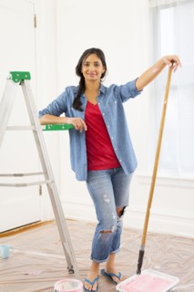 Mixed race woman painting room