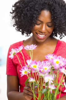 Mixed race woman holding bouquet of flowers