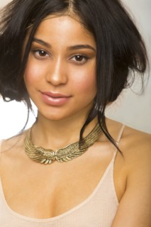 Hispanic woman wearing gold necklace