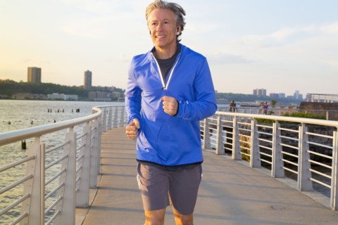 Caucasian man jogging on urban waterfront