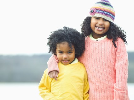 Mixed race children posing outdoors