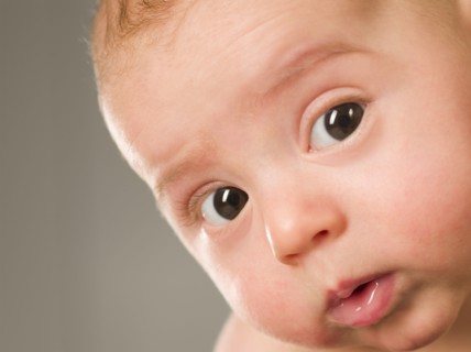 Curious mixed race newborn baby