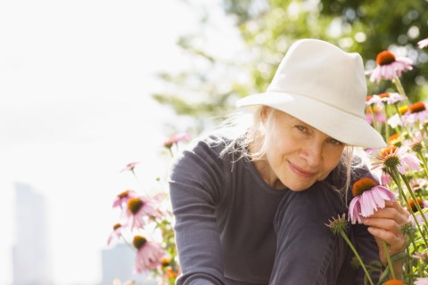 Smiling Caucasian woman holding flower
