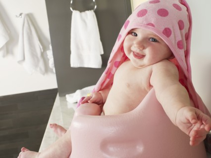 Caucasian baby girl siting in high chair