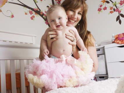 Mother holding baby girl in tutu